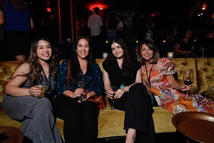 Guests on a velvet banquette at the Deal Room